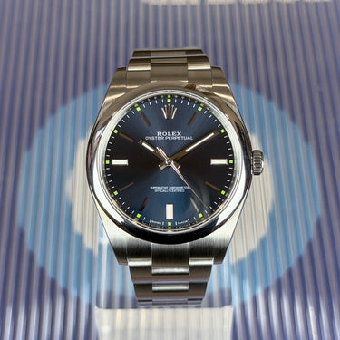 certified pre-owned Rolex Oyster Perpetual blue dial 39mm reference 114300 from 2015 in Geneva - Certified pre-owned - Minty Watches