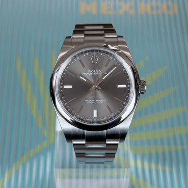 certified pre-owned Rolex Oyster Perpetual grey dial 39mm reference 114300 from 2017 in Geneva - Certified pre-owned - Minty Watches